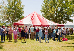 photo of festival tent with patrons in foreground